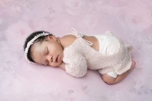 Baby girl in white outfit with headband, newborn photoshoot Melbourne