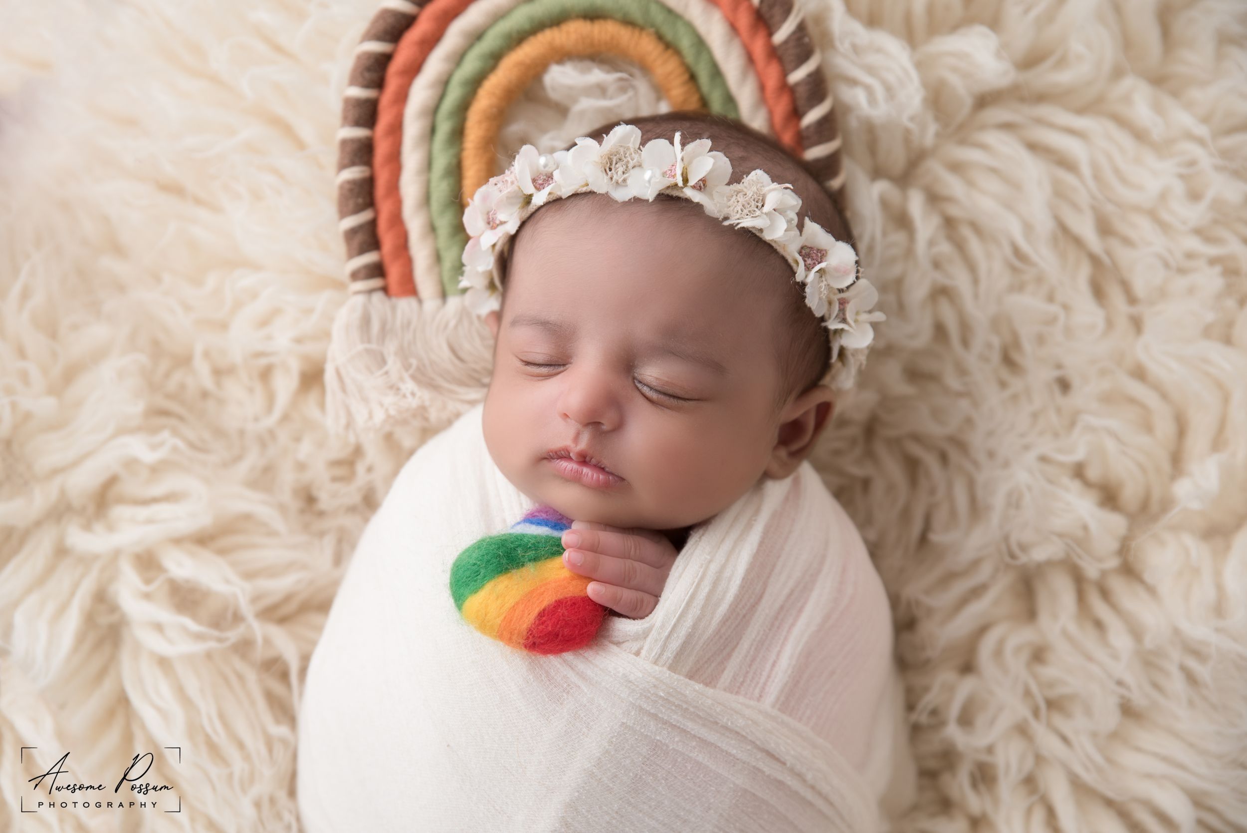 Newborn photography Melbourne, baby lying on floral backdrop studio