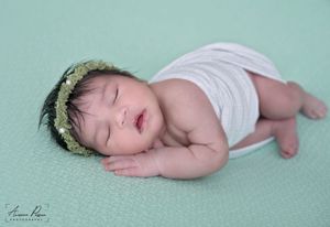 Newborn photography Melbourne, baby lying on fur rug studio session