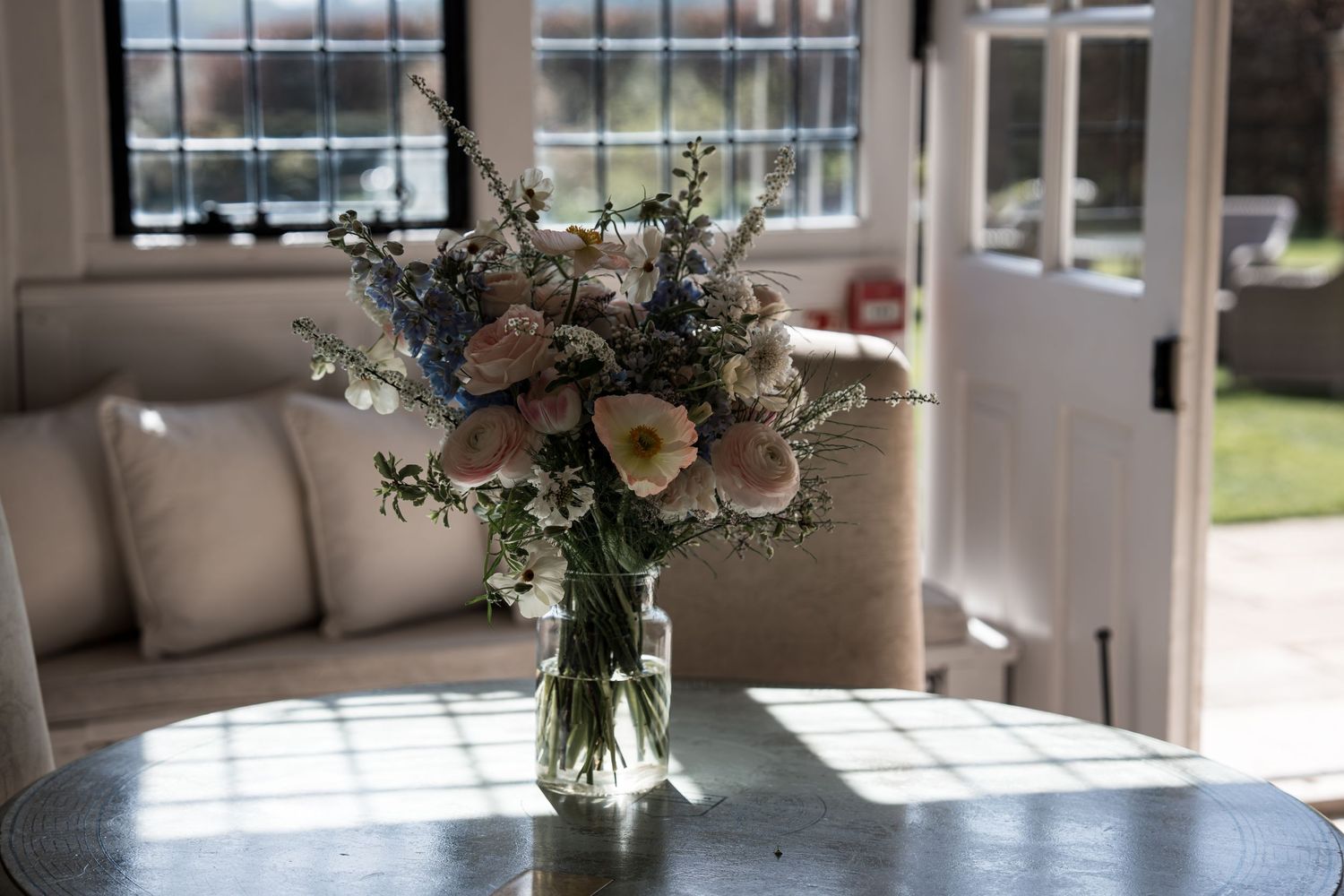 Elegant bridal bouquet of pink and white flowers in a vase on a table.