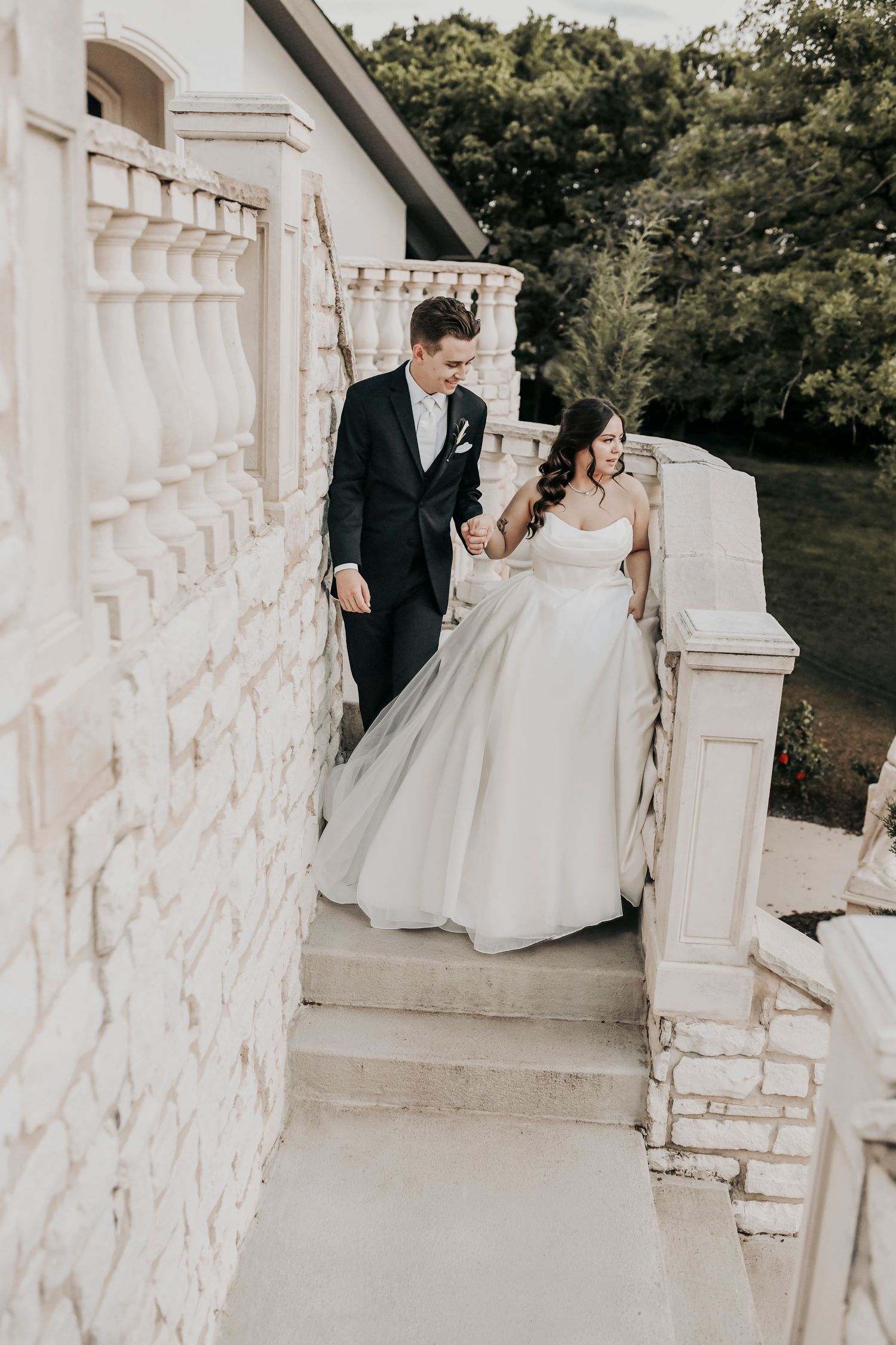 Bride and groom walking together at sunset after their wedding ceremony
