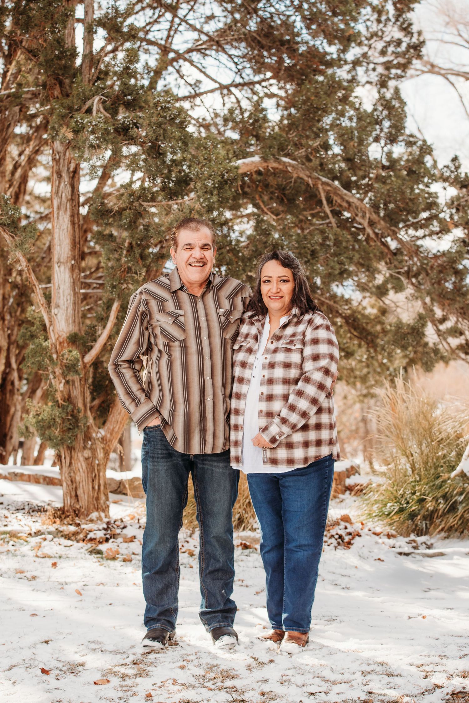 Couple enjoying scenic mountain view surrounded by golden aspen trees in fall.