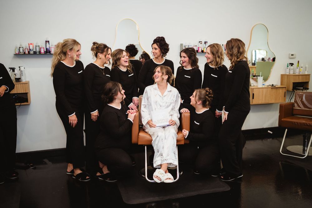 A group of people dressed in black and white gather in a room for a formal event or gathering.