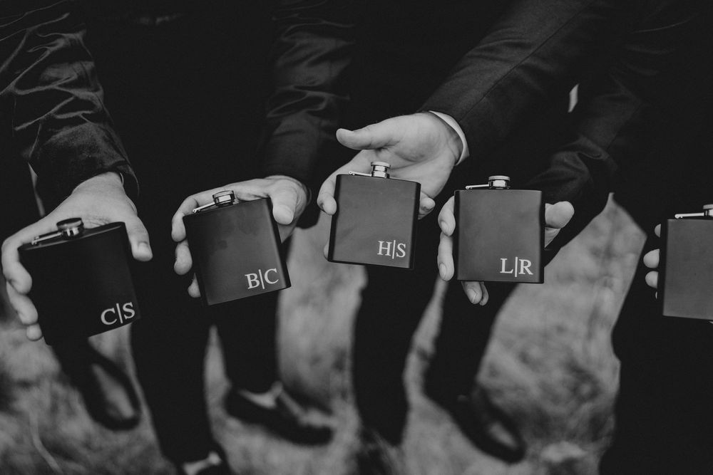 Black and white image of multiple microphones lined up in a row for a press conference or media event.