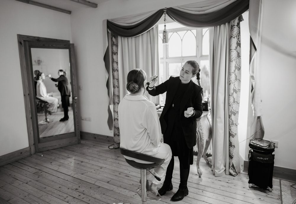 A black and white photo collage shows a couple dancing together in an elegant room with draped curtains and windows.
