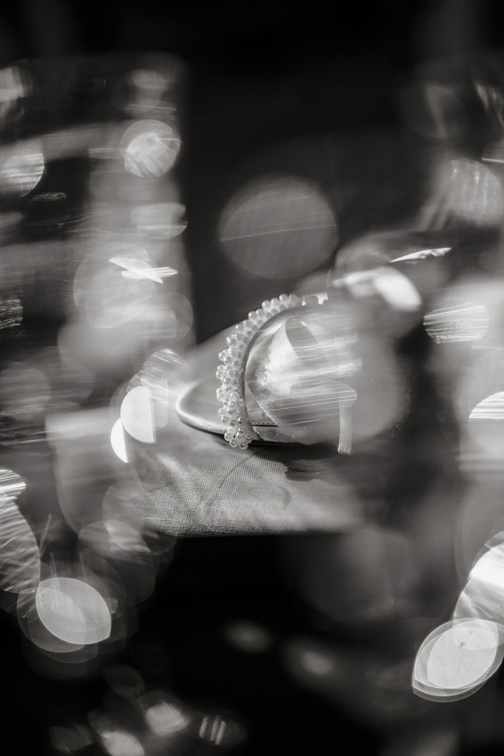 Abstract black and white photograph showing blurred motion and bokeh light effects creating an ethereal pattern.