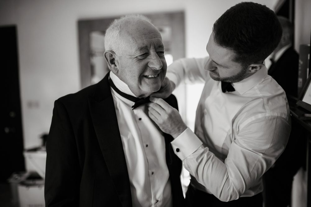 Black and white wedding photos showing intimate candid moments between couples during their special day.
