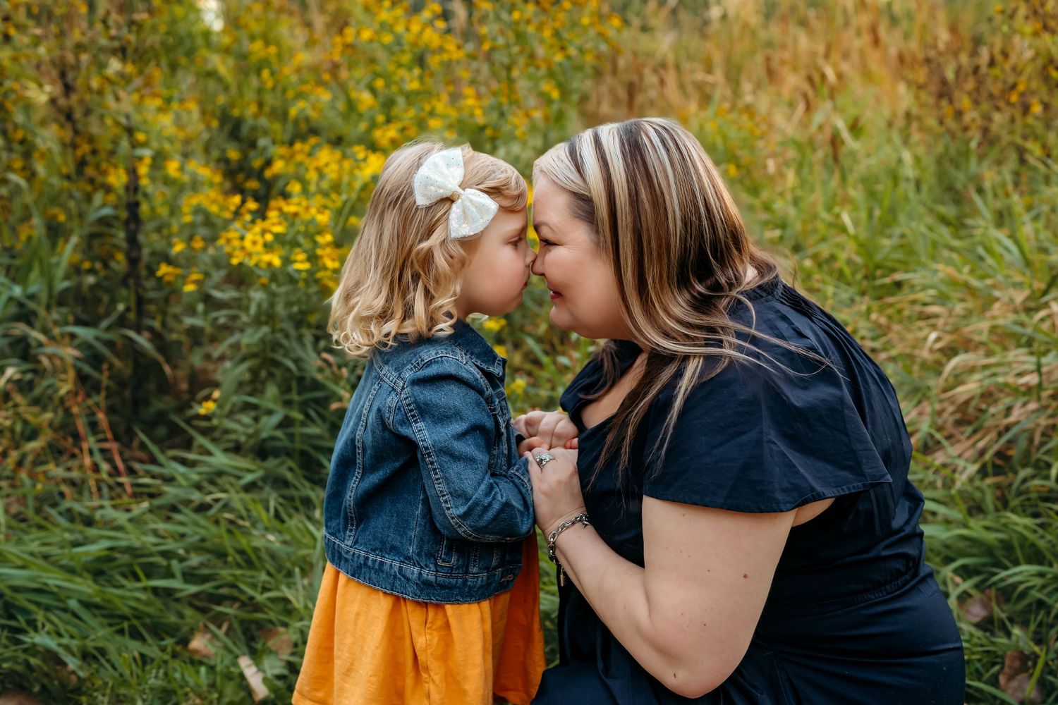 A series of candid outdoor portraits showing tender moments between people in a natural autumn setting with golden flowers.