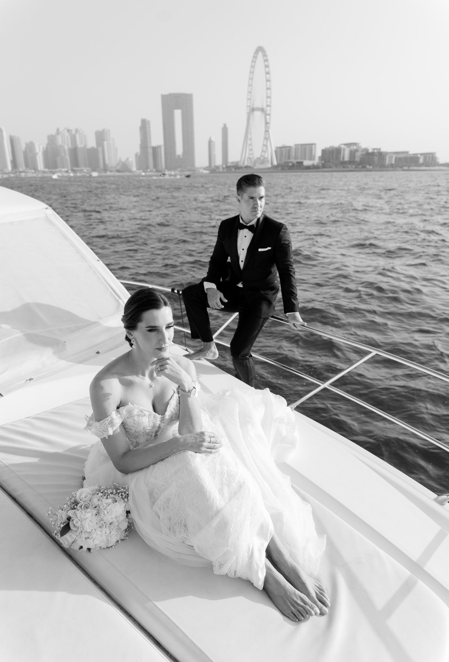 Romantic couple enjoys a boat ride along Chicago's waterfront skyline on a cloudy day.