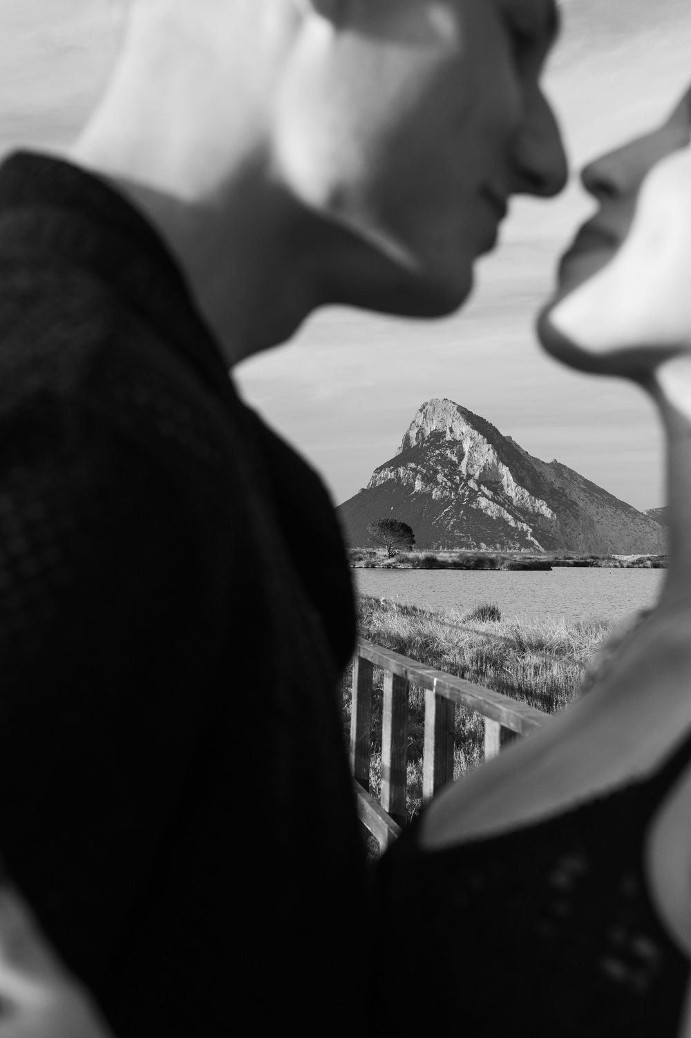 Artistic black and white shot of a couple with mountain vista.