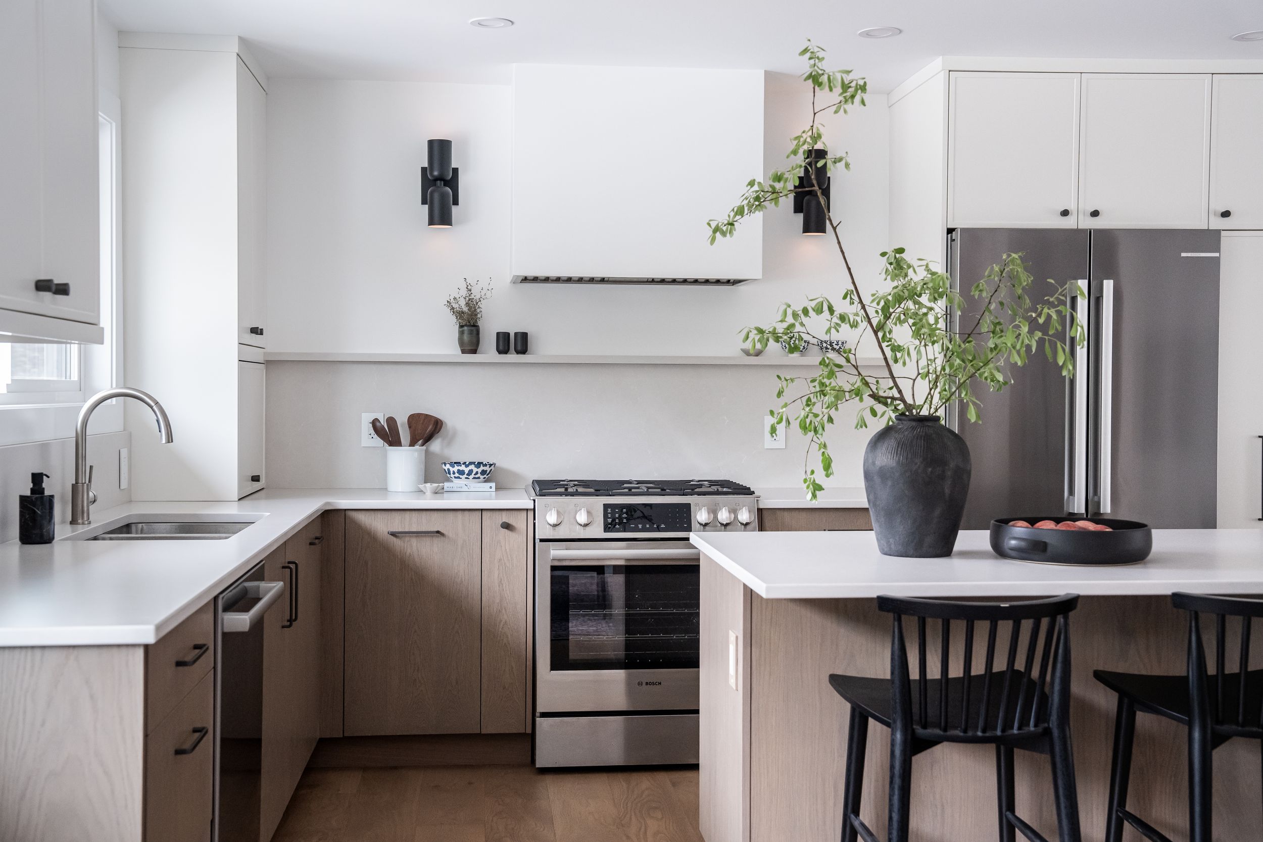 Modern kitchen interior with white cabinets and wood accents — professional real estate photography in Revelstoke.