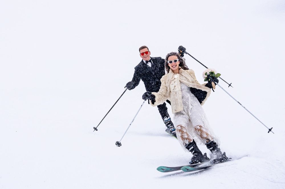 Winter wedding couple skiing together in snow — adventure wedding photography in Revelstoke.