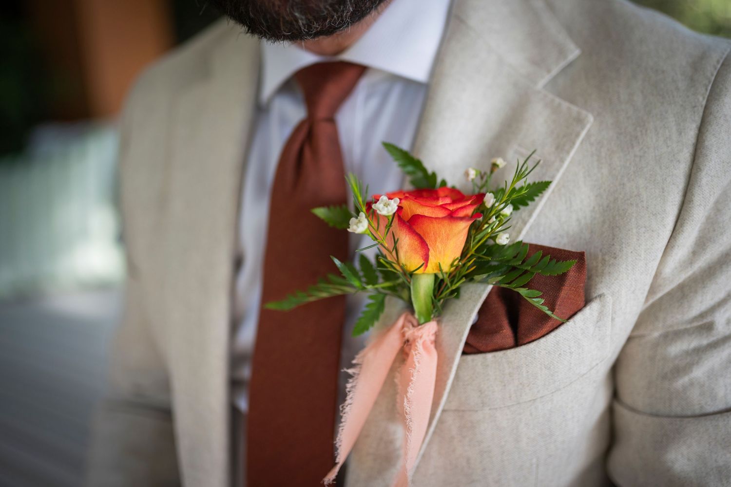 A series of seven close-up photos showing orange rose boutonnieres with green foliage on tan suit jackets.