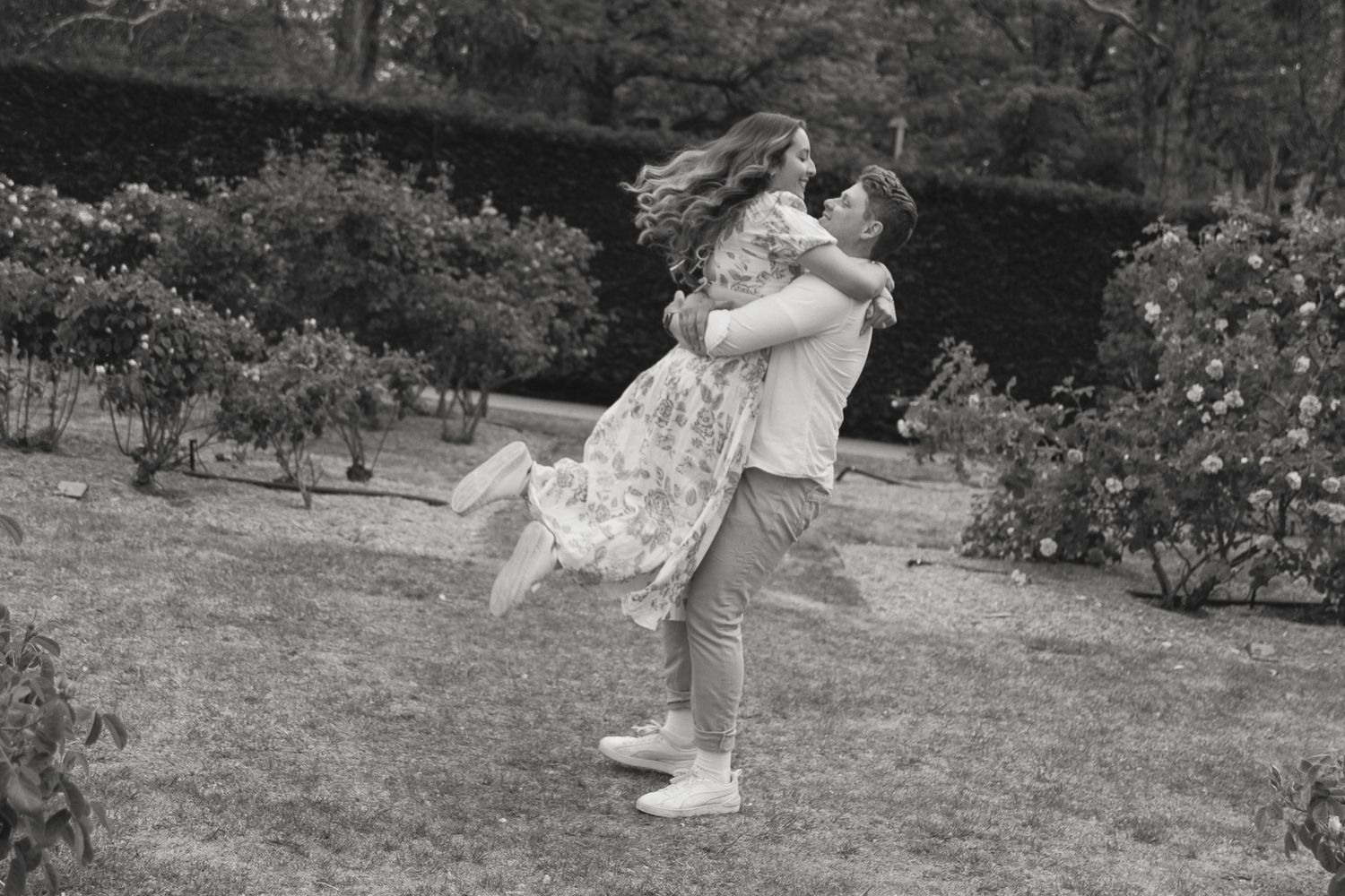 A husband and wife spinning through the rose garden.