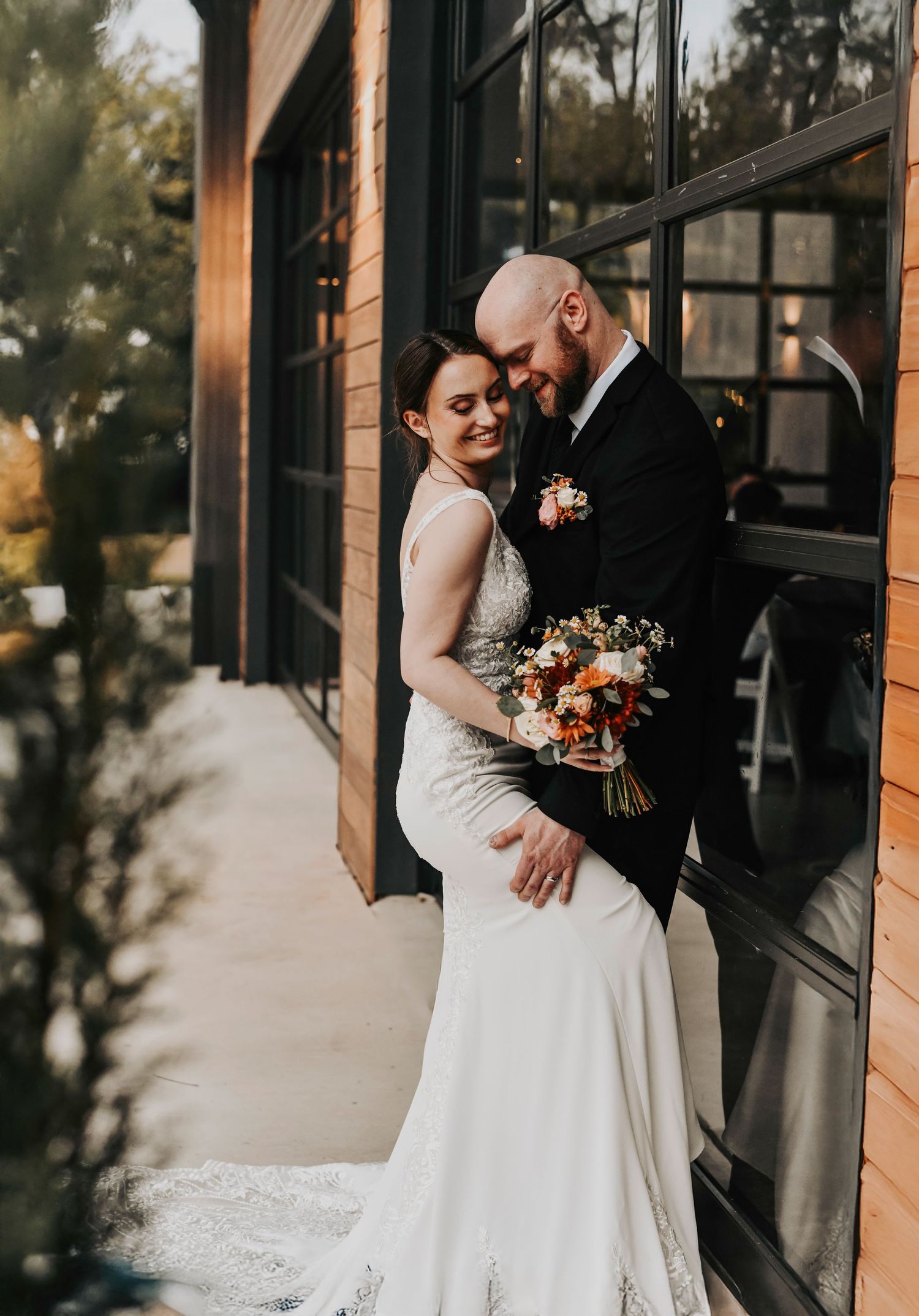 a romantic moment between a husband and wife as they pose for their wedding photos with april pinto photography