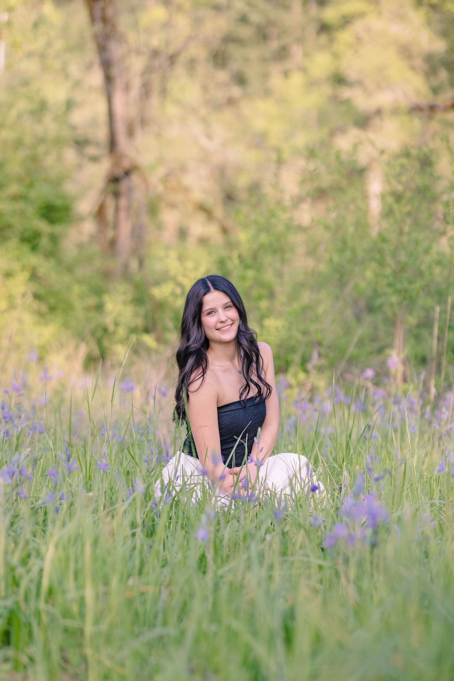 Portrait session in a field of purple wildflowers during golden hour.