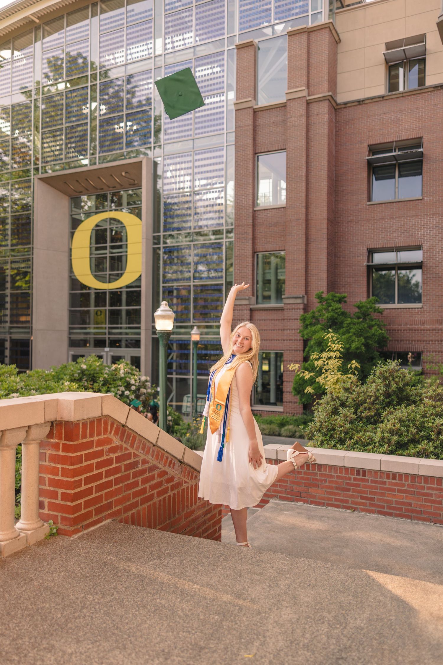 Graduation photos showing diploma toss sequence in front of brick university building.