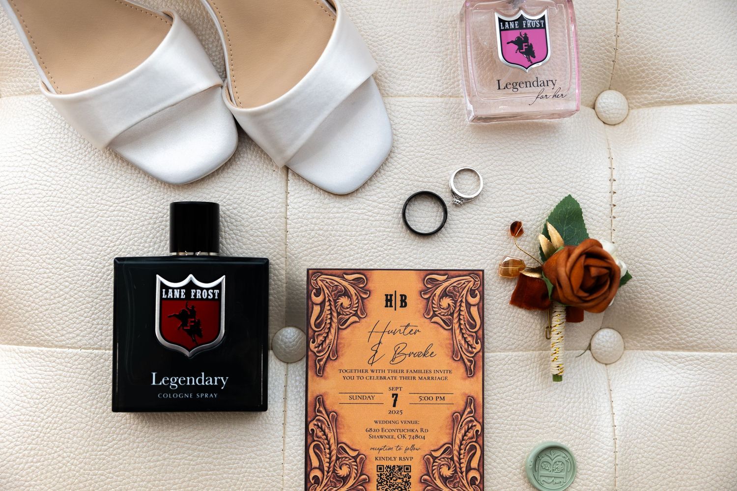 A flat lay arrangement of beauty and cosmetic products including perfume bottles and jewelry on a white surface.