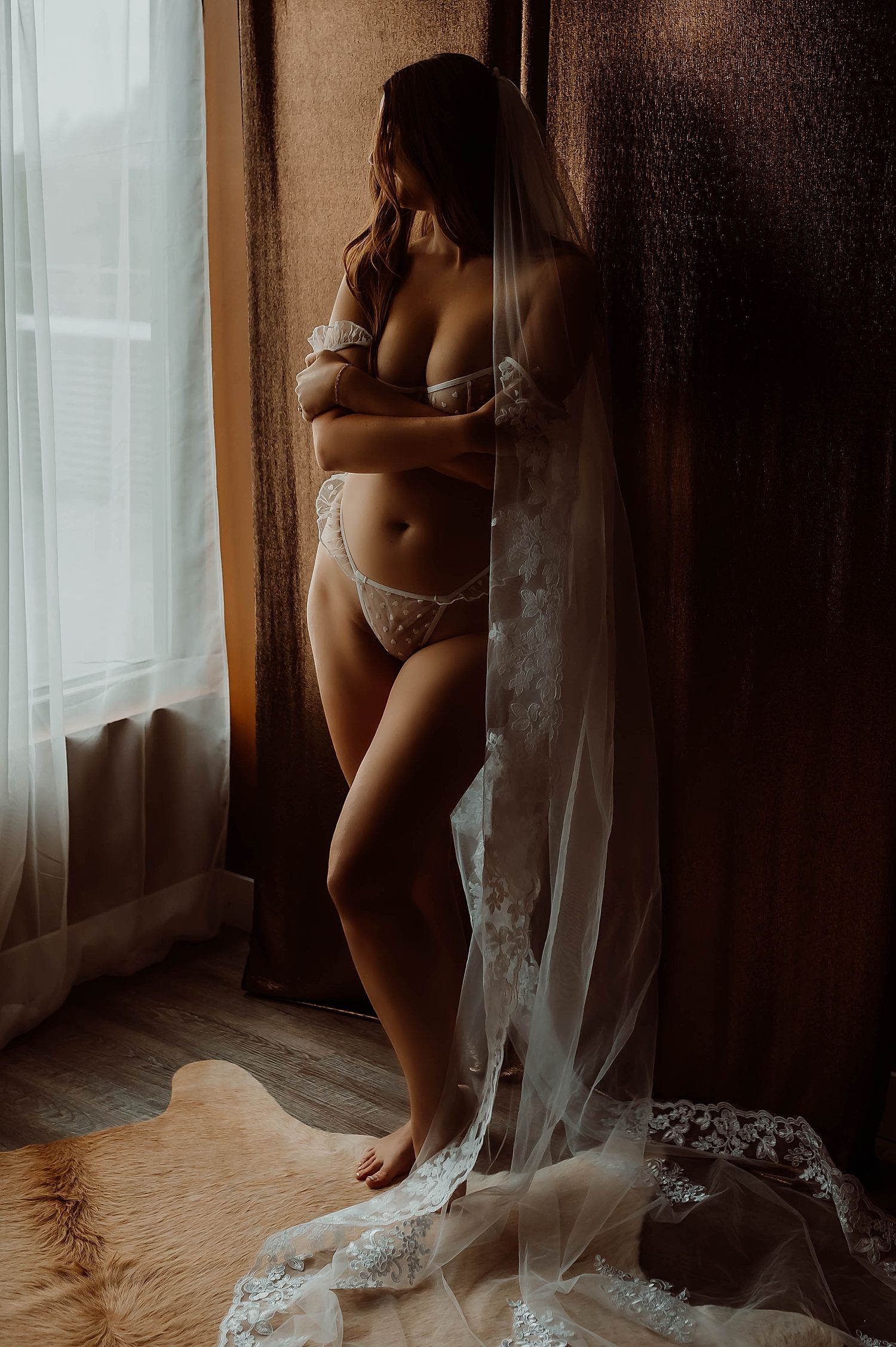Artistic boudoir photography series showing silhouetted figure against sheer curtains in moody natural lighting.
