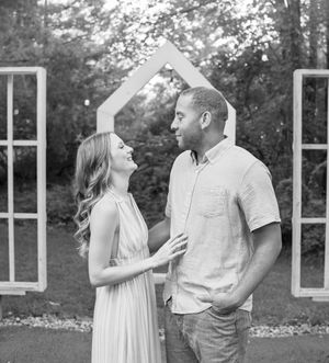 A couple shares intimate moments in a black and white photo series set against a natural backdrop.