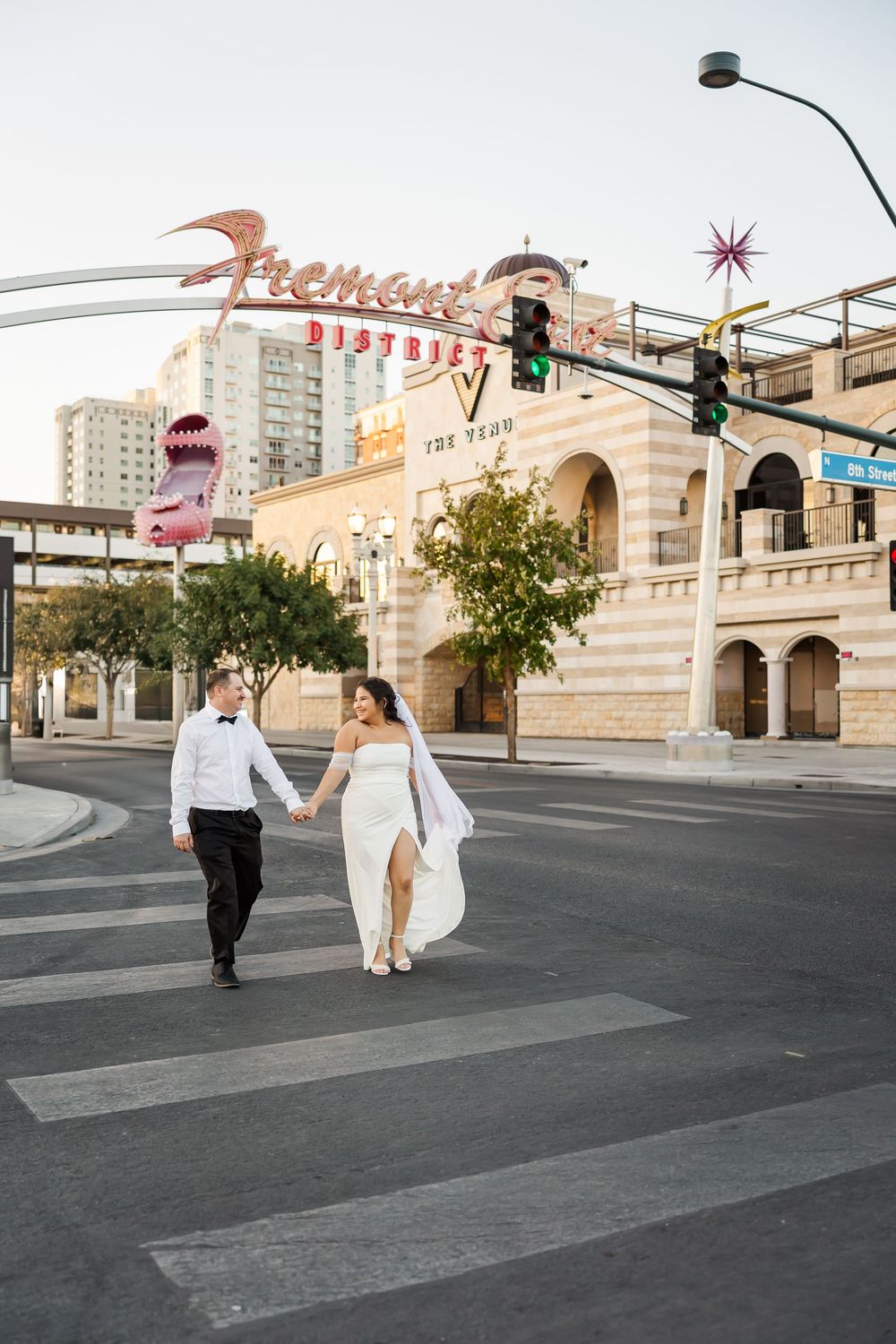 A couple walks hand in hand across a crosswalk near the Flamingo Hotel in Las Vegas.