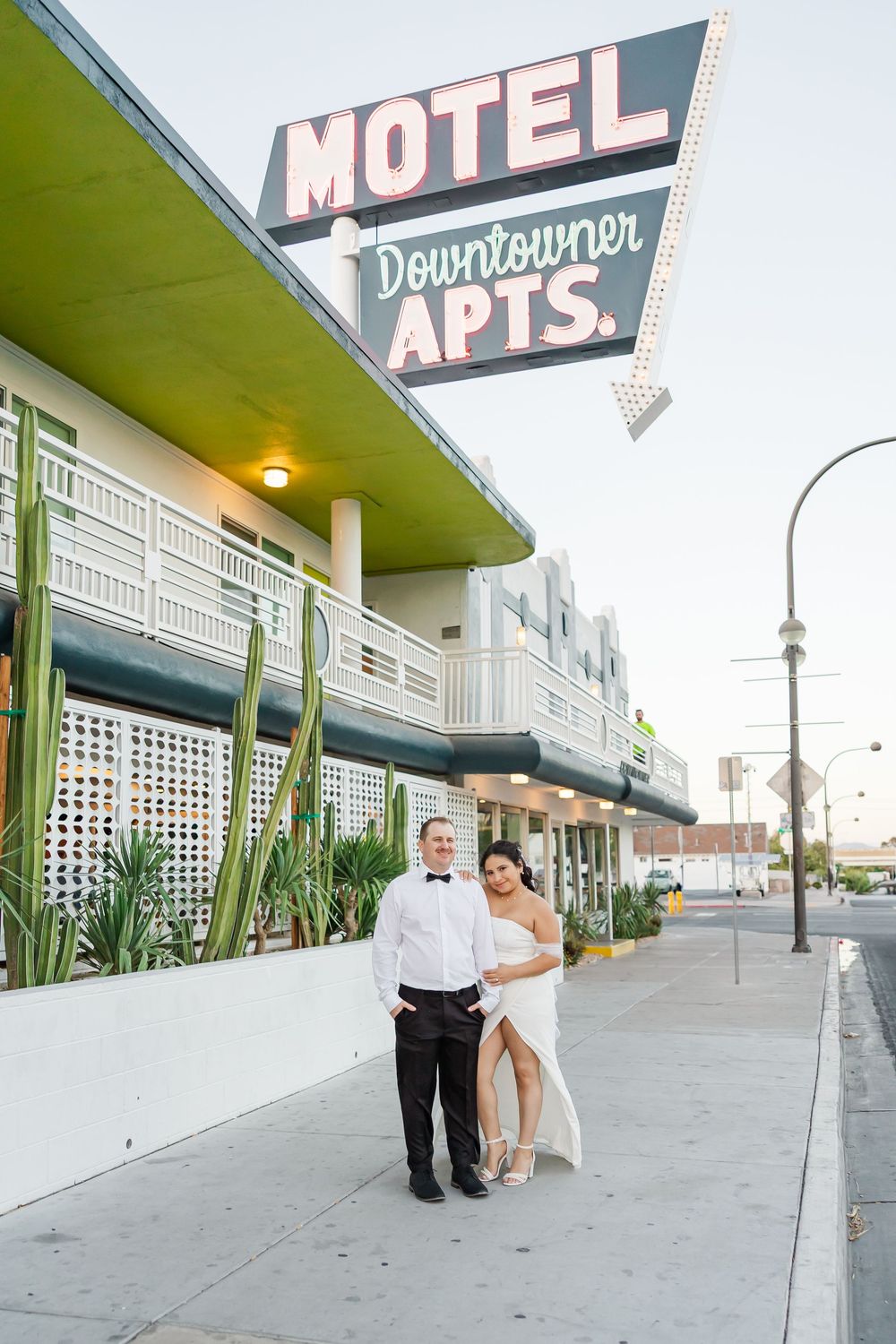 Retro motel exterior with vintage signage and mid-century architecture creates nostalgic backdrop for wedding photos.