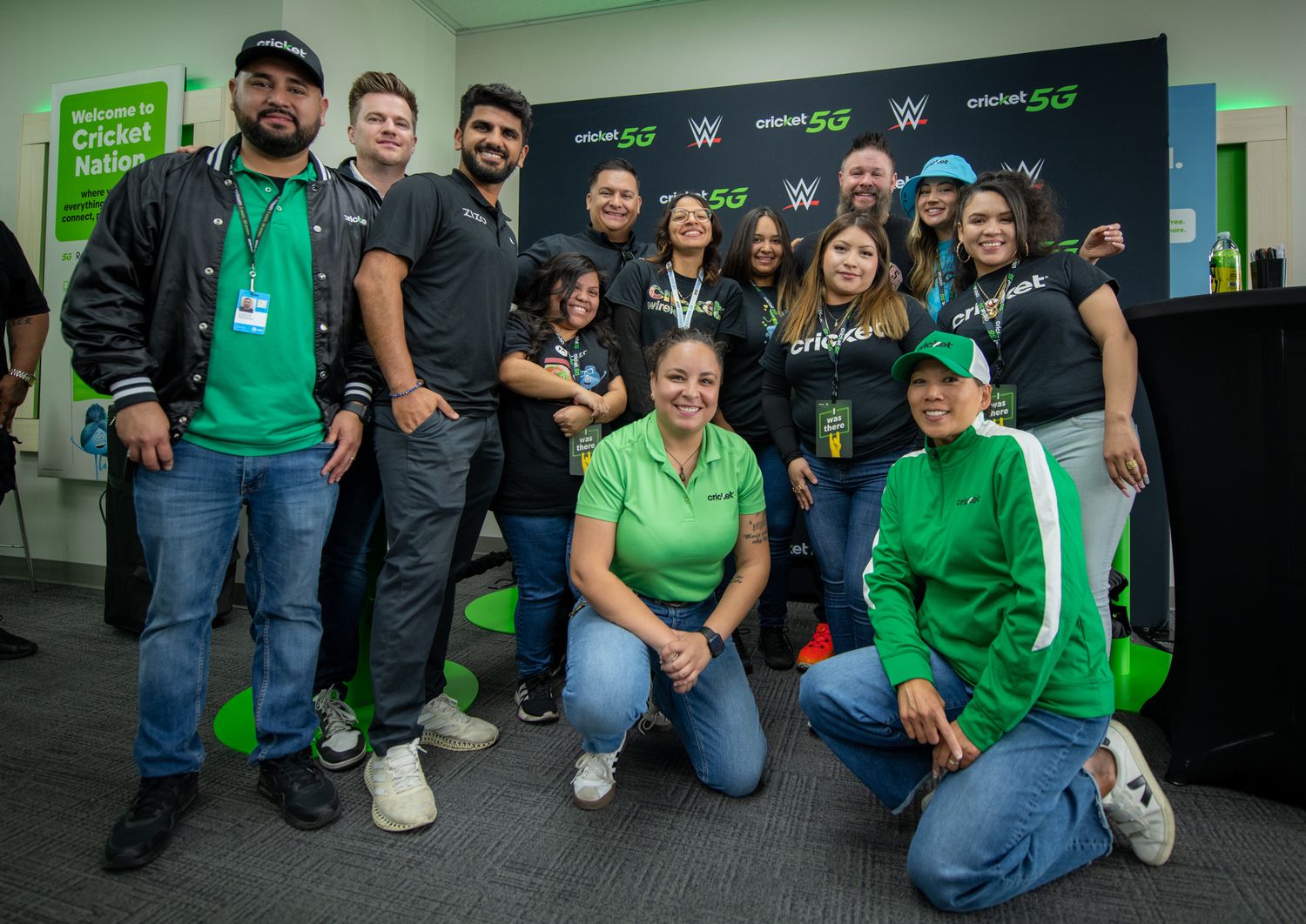 Long line of customers waiting outside Cricket Wireless store locations during promotional event.