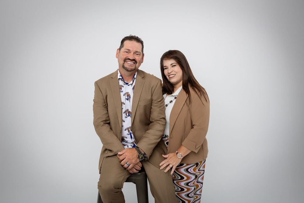 Studio photos of couple in coordinated casual outfits showing affection and laughter.