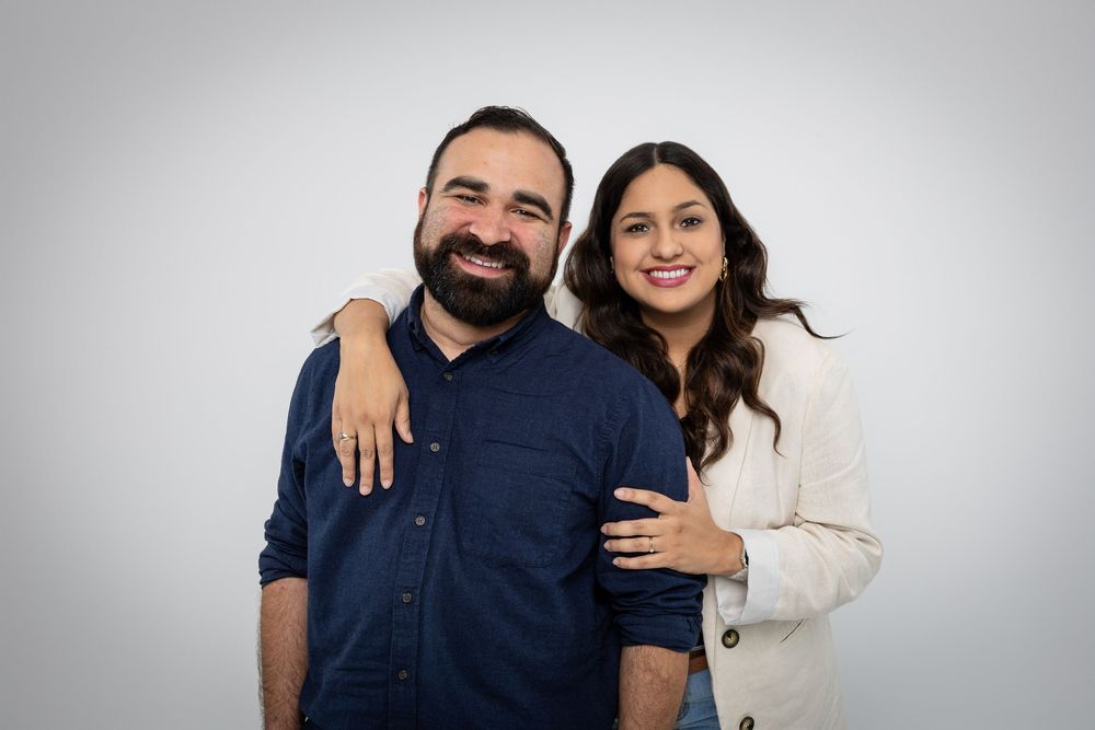 Collection of casual studio photos showing couple embracing in navy and cream outfits.