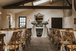 A rustic wedding venue interior with wooden cross-back chairs, white draping, and exposed beam ceilings photographed in sequence.