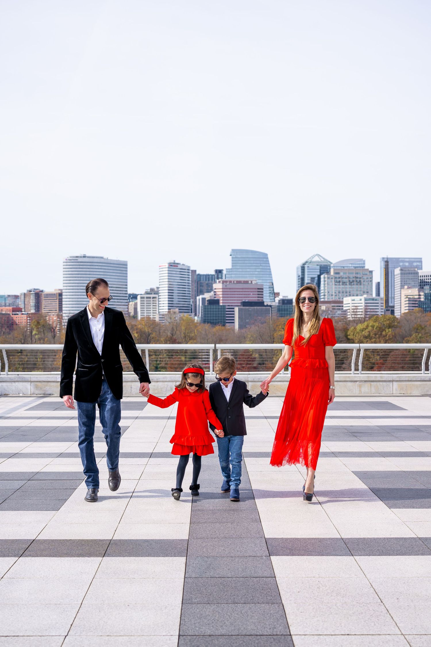 A row of sequential images shows people walking together along a tiled rooftop plaza with a scenic city skyline in the background.