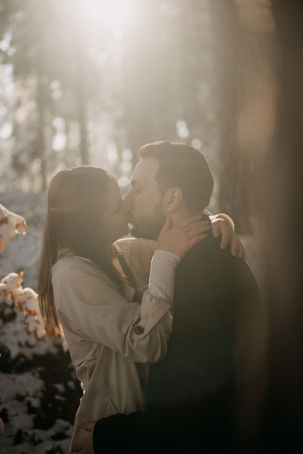Romantic embrace in a dimly lit setting with dreamy bokeh effect.