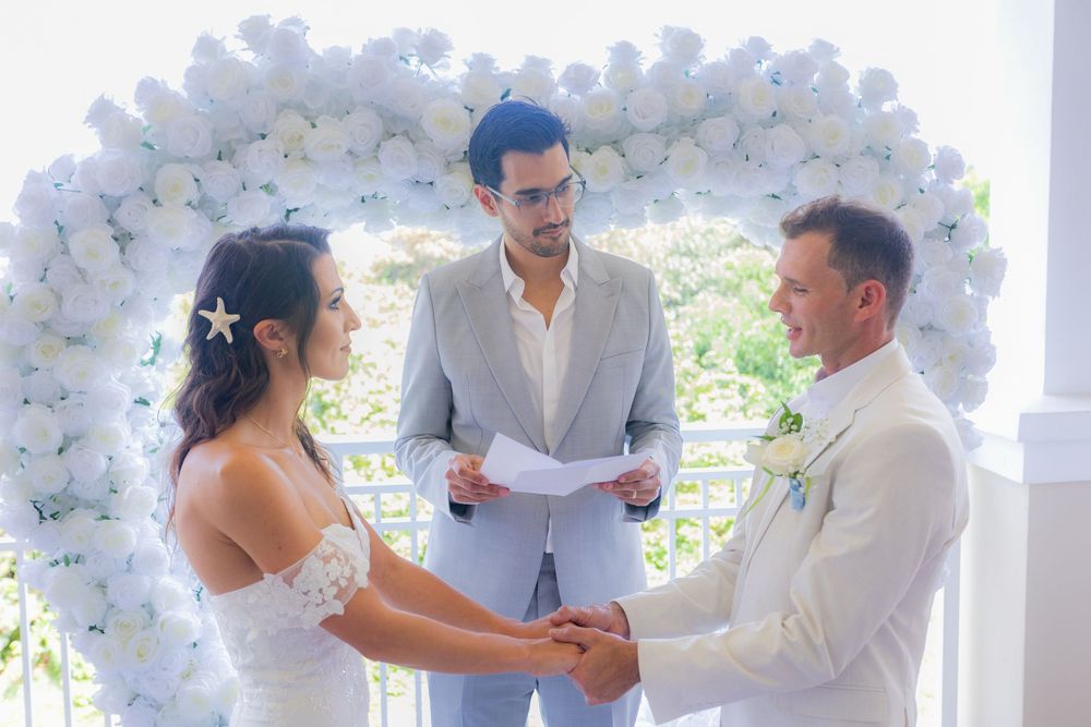 Bride and groom holding hands during ceremony at palm beach shores community center