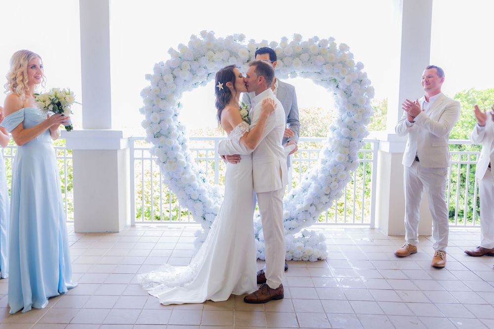 Bride and groom first kiss  at palm beach shores community center micro wedding
