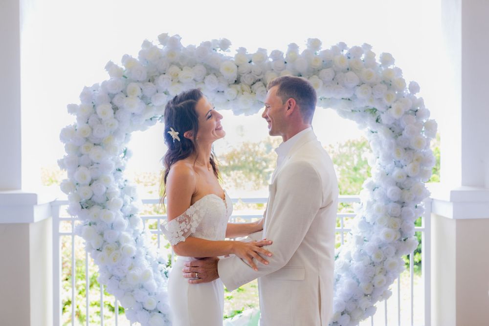 Bride and groom holding hands at ceremony in palm beach shores community center micro wedding