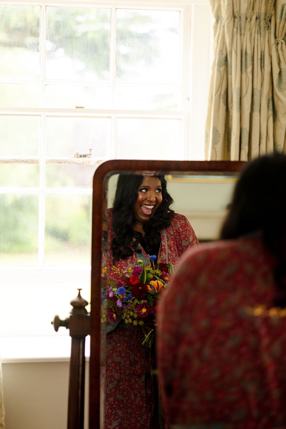 Bright sunlit room with window reflections and floral patterns.