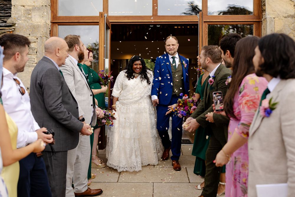 Wedding celebration with guests gathered in a rustic stone venue.
