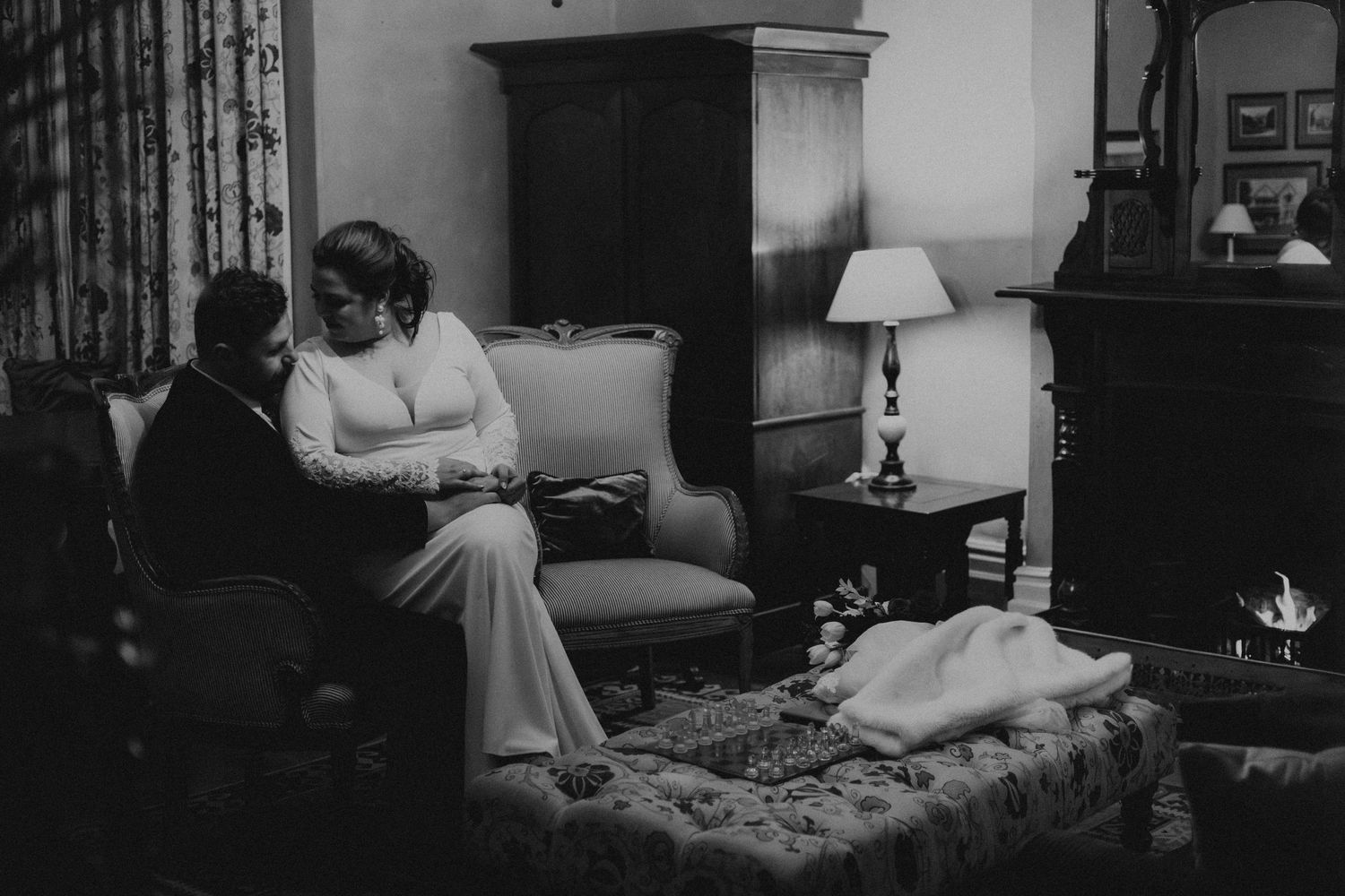 Intimate moment shared in cozy living room with fireplace.