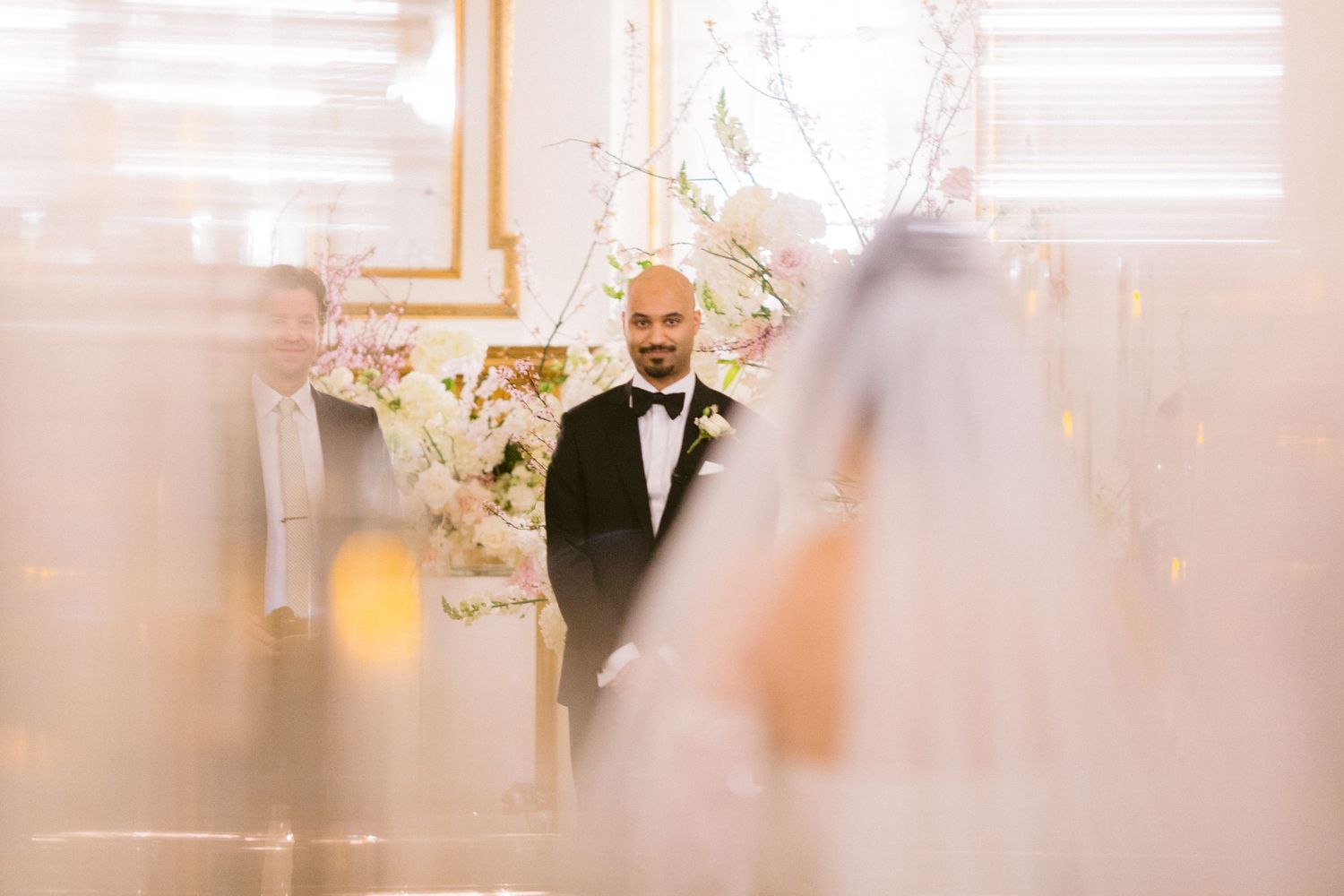 A series of five soft-focus wedding photos showing romantic moments between a couple in formal attire.