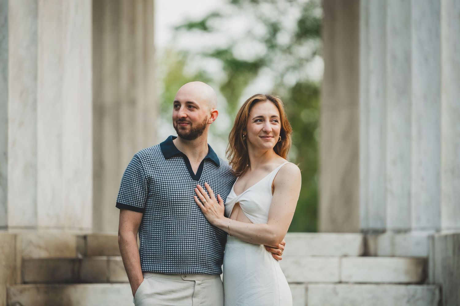 Portrait of Alex and Andrew posing together between the marble columns at the DC War Memorial