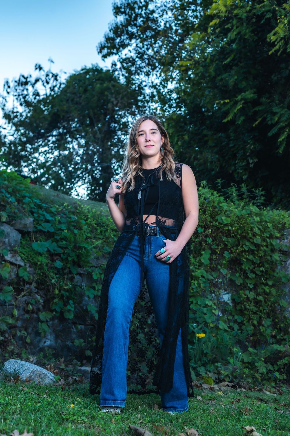 A series of outdoor portrait shots against a natural backdrop of trees and greenery in casual attire.