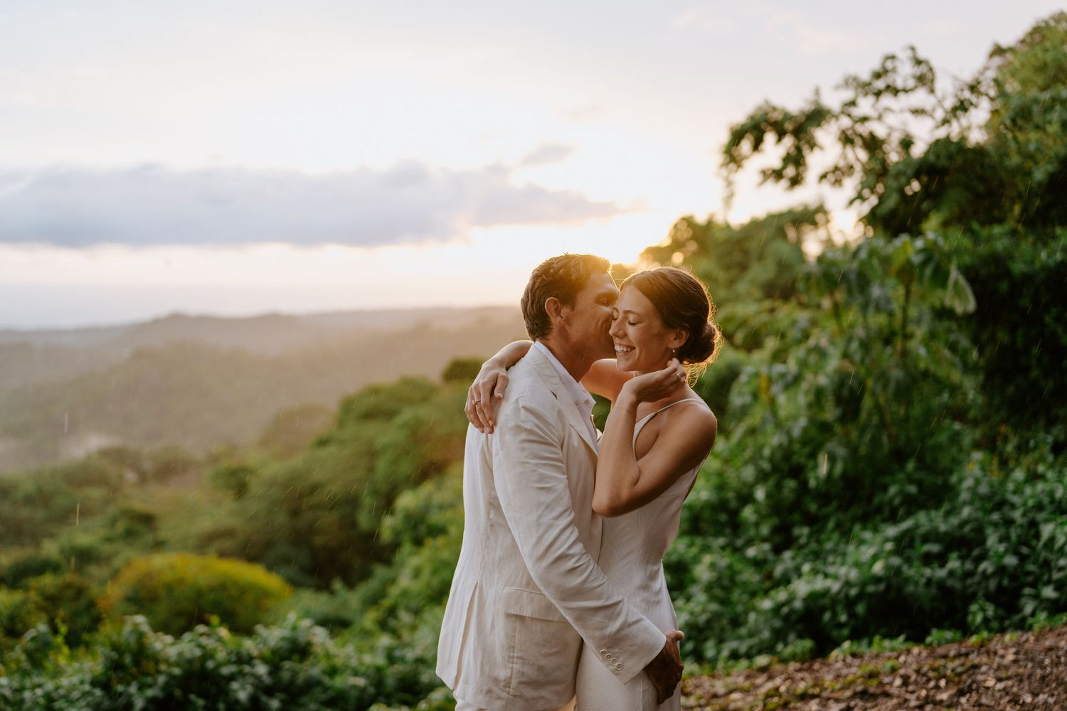 couple sharing a kiss during sunset in Nosara