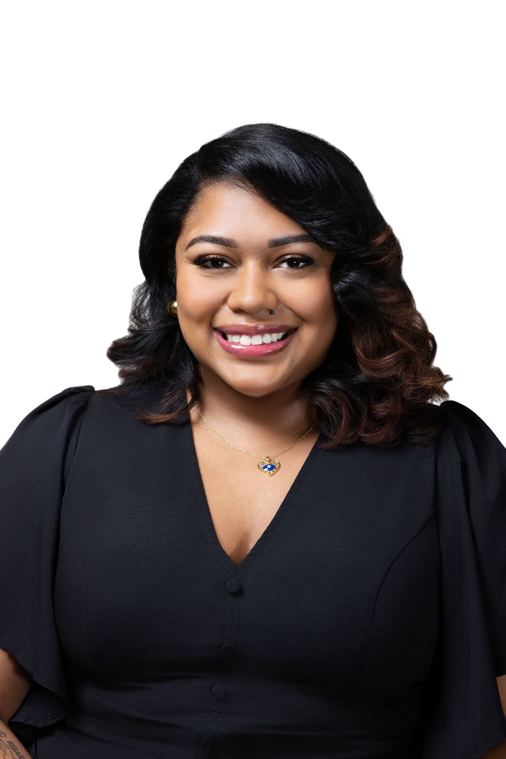 Professional headshot in black v-neck blouse against neutral studio backdrop.