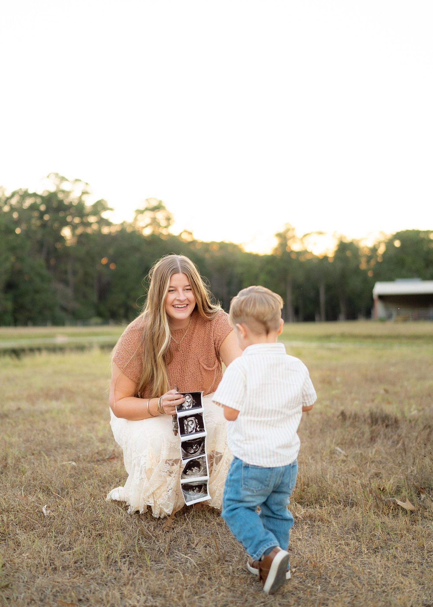 Energetic toddler running toward mom during a playful family photo session.