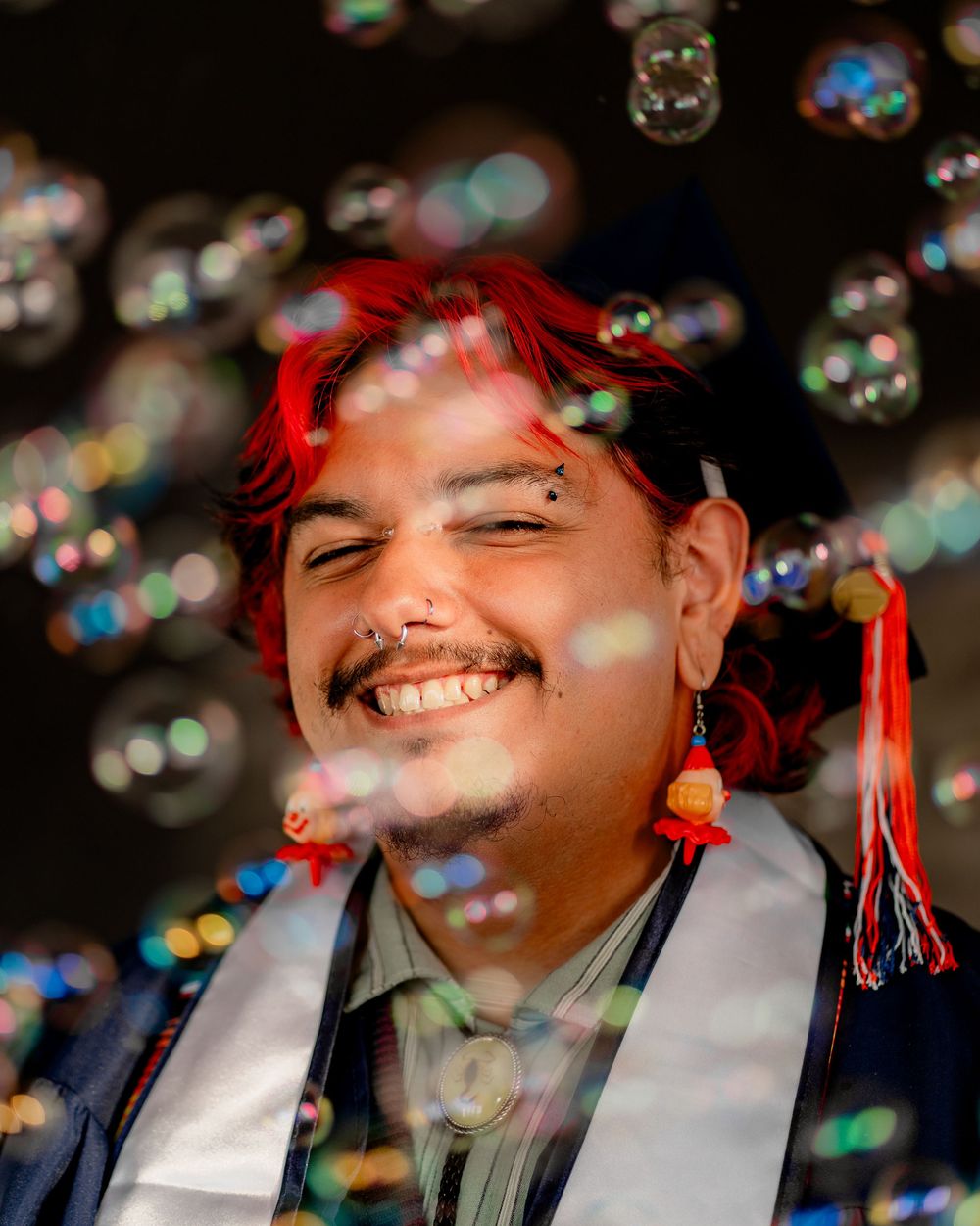 A series of portraits showing someone wearing a white shirt with soap bubbles floating in the foreground.