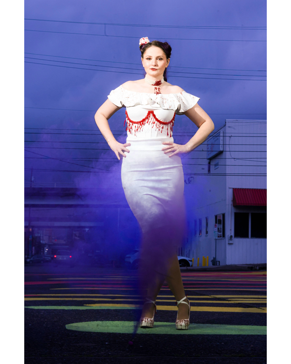 A figure in retro 1950s style clothing with a white top and gray pencil skirt poses against a purple-lit urban backdrop.