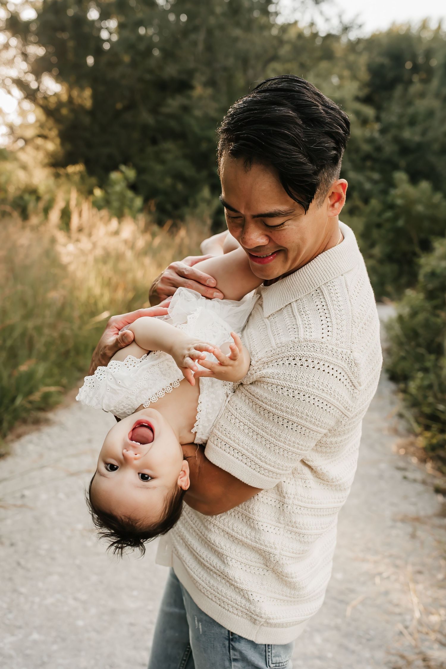 Dad plays with daughter during family photo shoot at Summit Park.