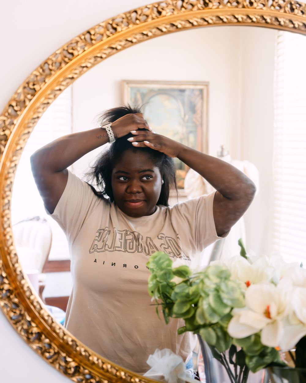 Getting ready sequence showing wedding day preparations in front of an ornate gold mirror.