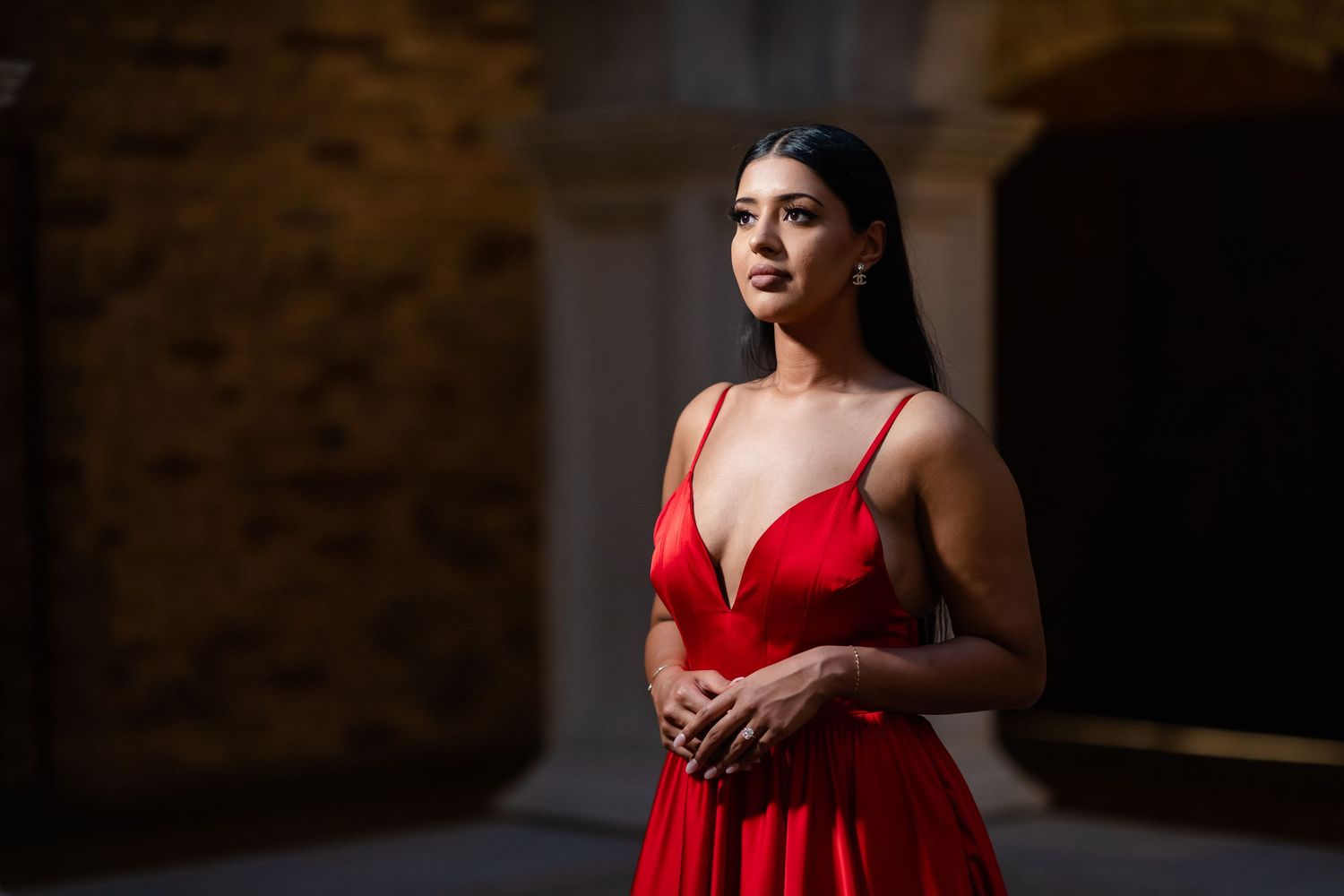 A woman in a vibrant red dress poses elegantly in various positions against a dark background.