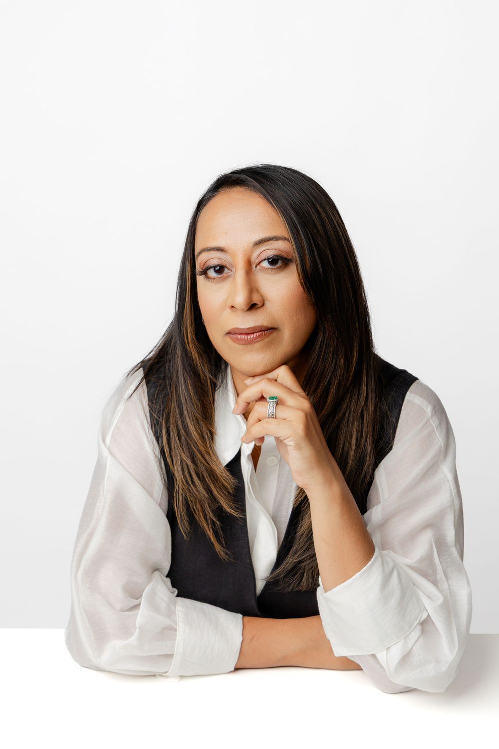 Professional headshots showing a person in a white blouse and black vest against a white background.